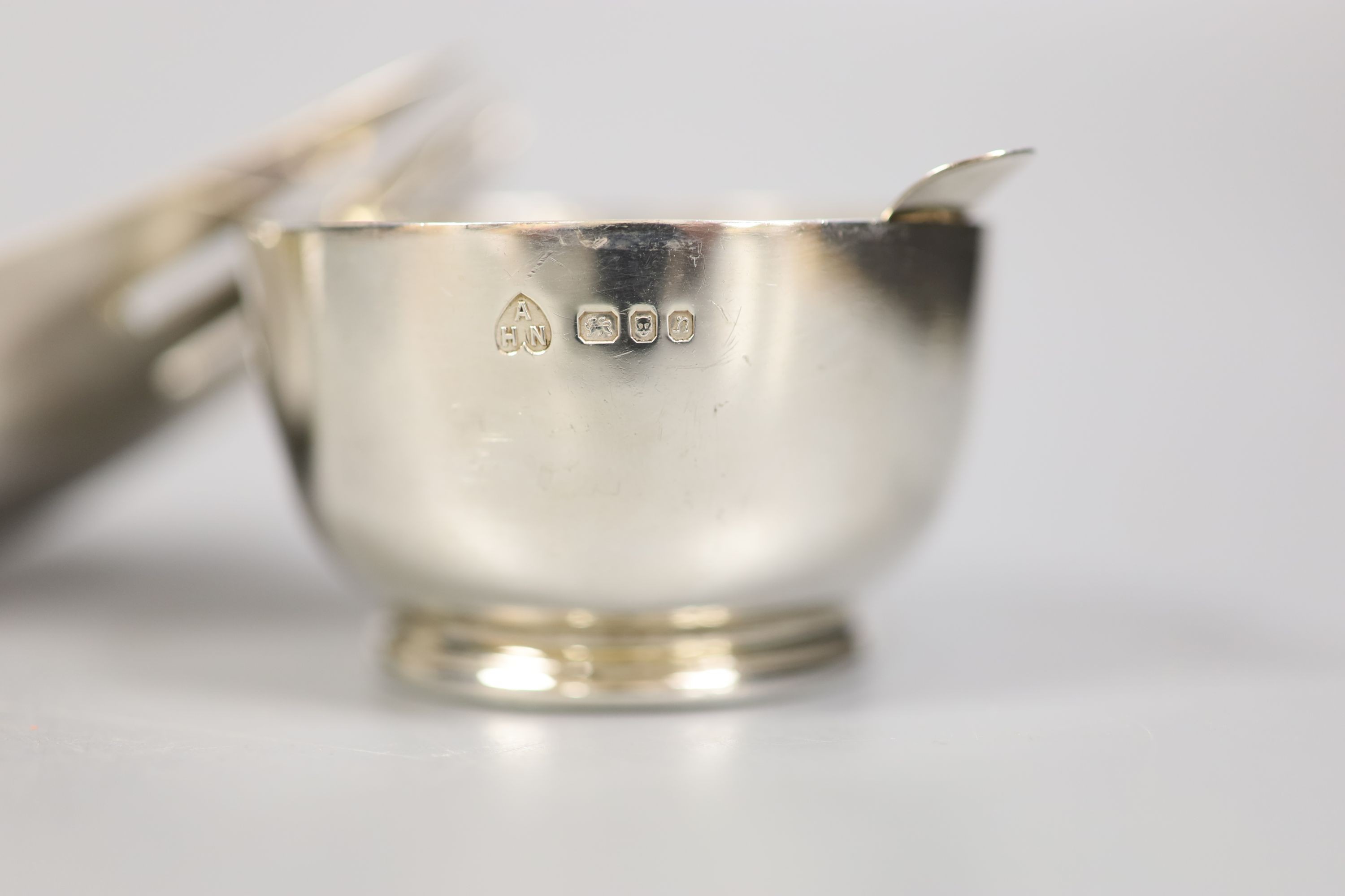 A small group of silver and white metal items including a William IV mounted coaster, London, 1830, 12.9cm, a small silver bowl and pill, box, a Georgian caddy spoon, two Austro-Hungarian salts, and 800 egg cup, a Dutch